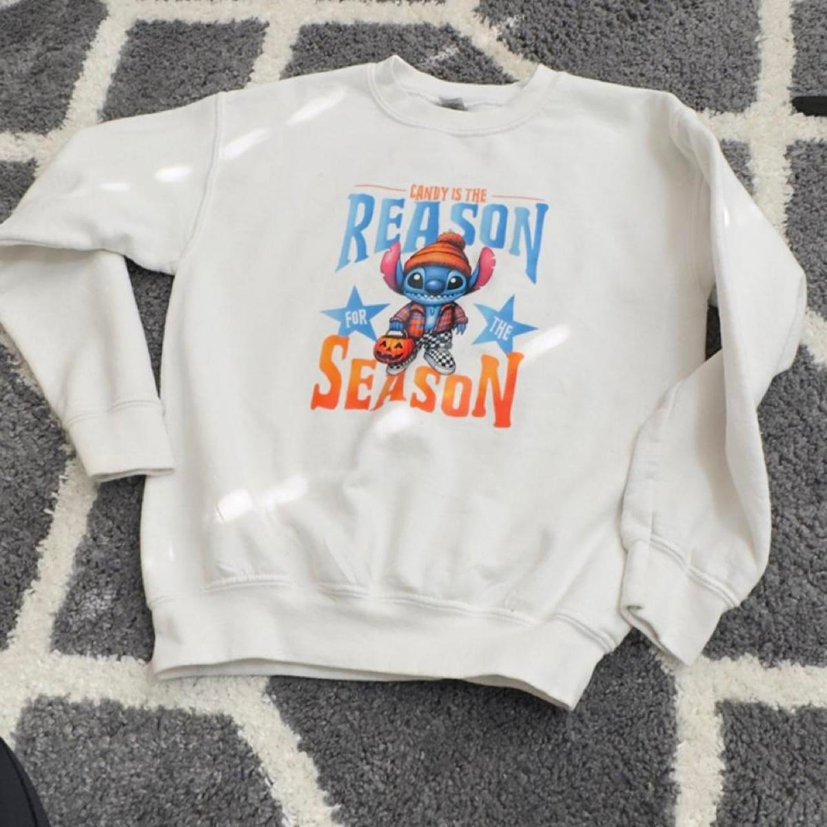Disney Stitch "Candy is the Reason for the Season" crewneck sweatshirt in size S. Cotton & polyester blend with graphic of Stitch holding a candy cane with the words 'CANDY IS THE REASON FOR THE SEASON'. #halloween #holiday #stich